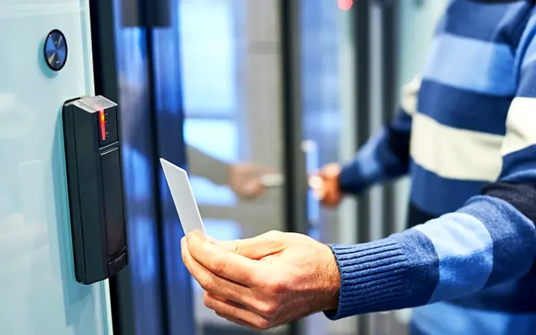 Employee presenting an access card to a door reader