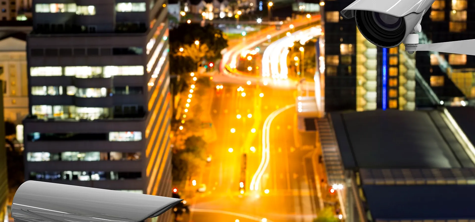 CCTV cameras overlooking a city street with traffic at night