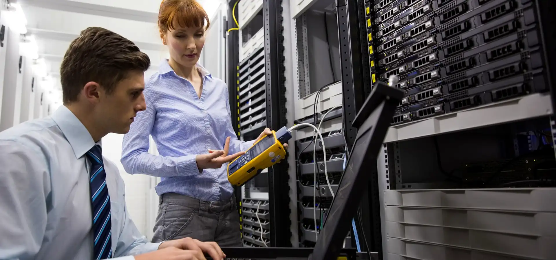 Engineers testing equipment in a server room during commissioning