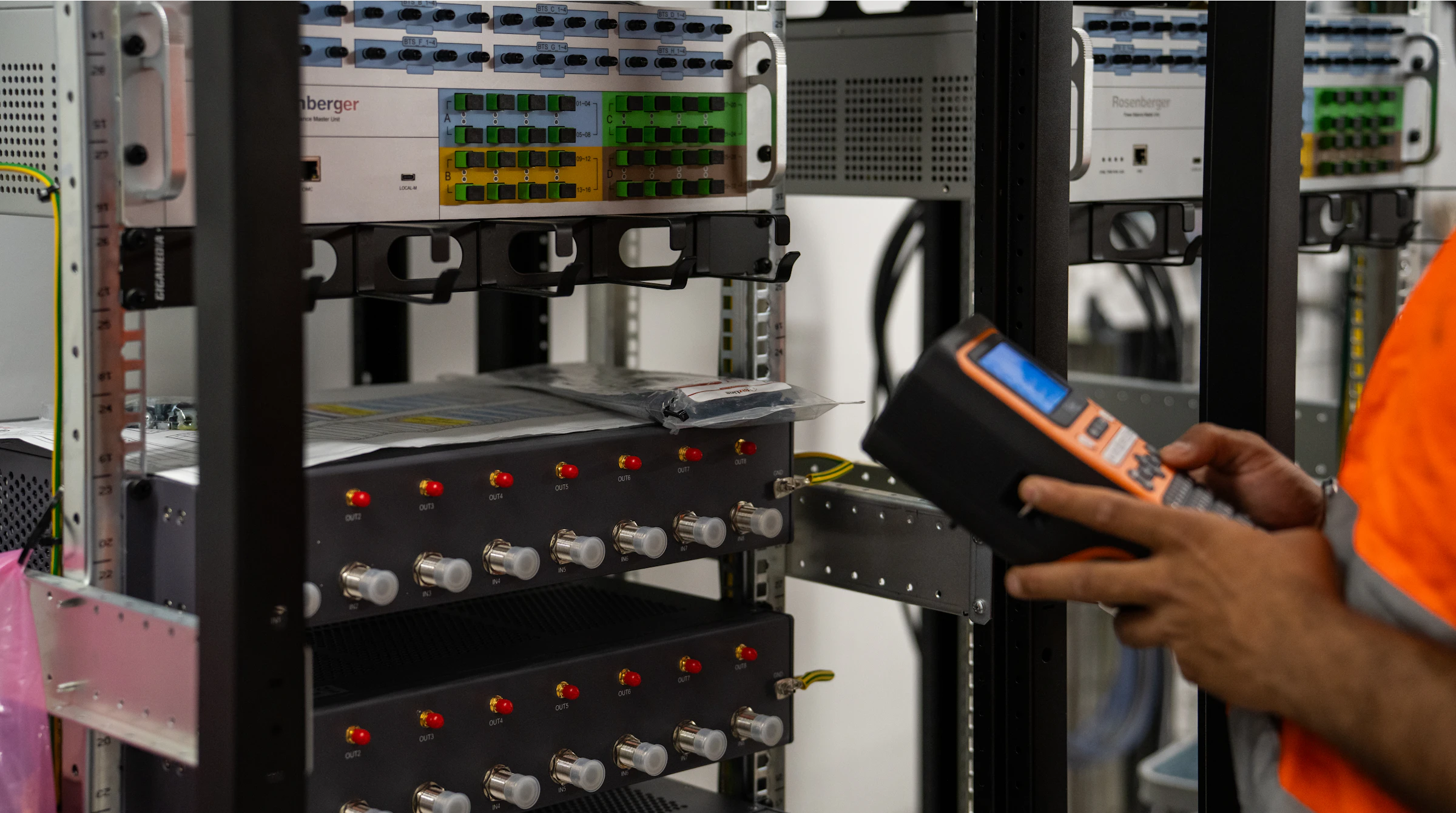 Technician testing rack equipment during scheduled maintenance