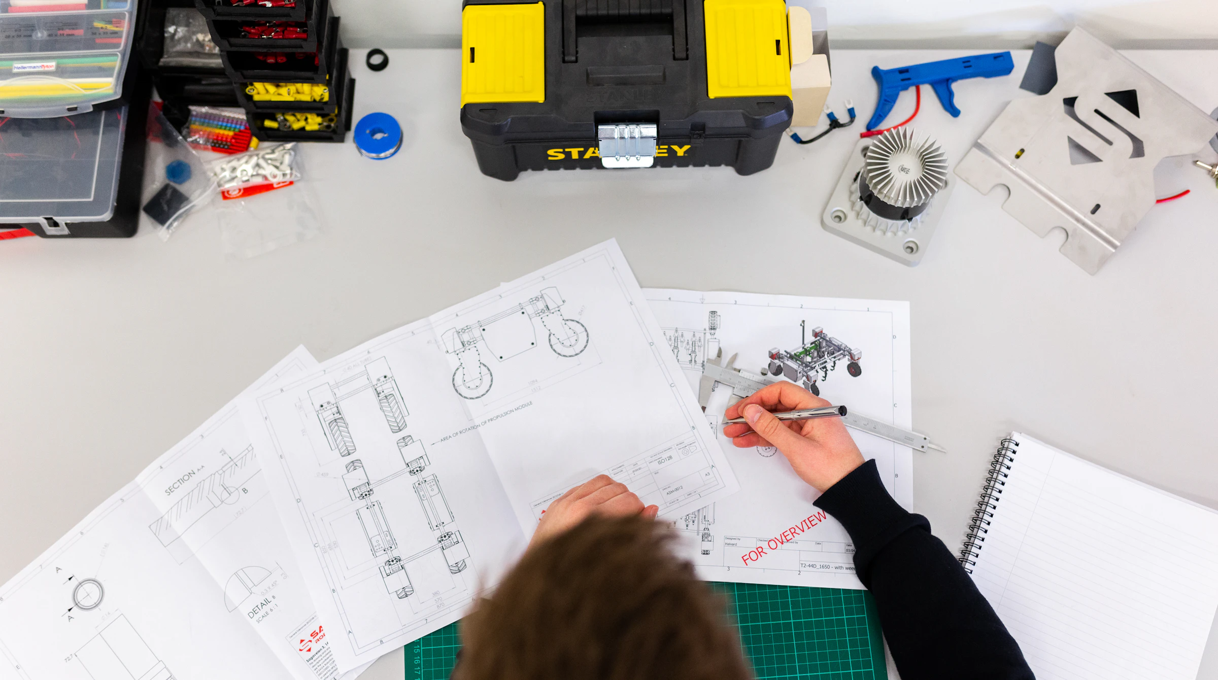 Engineer checking technical drawings for a submission